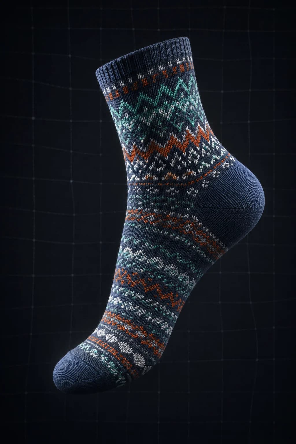 A single knitted patterned sock suspended in a dark void, lit from one side, gently twisted.