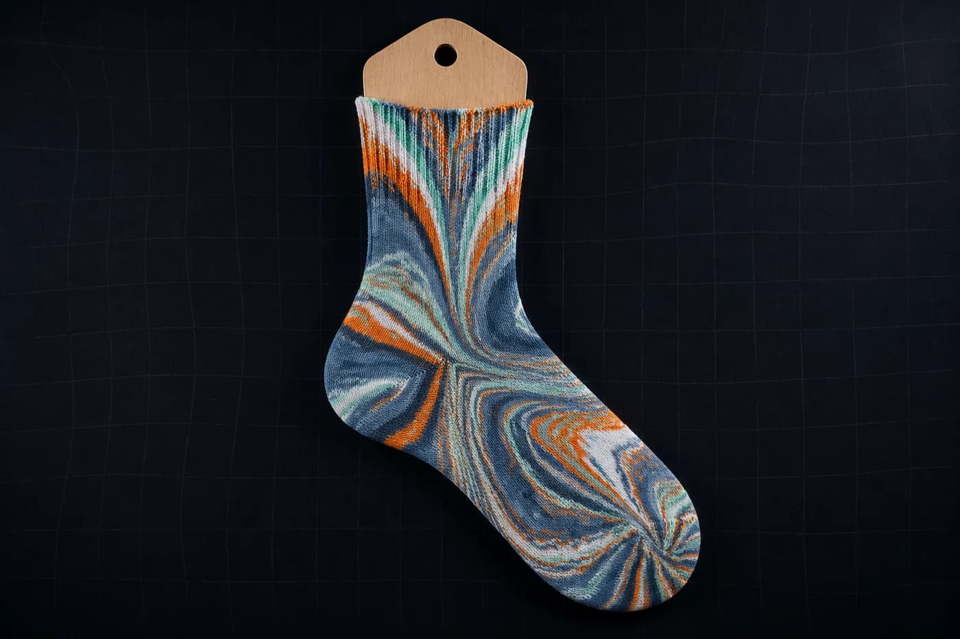Irregular marbling on a sock form. Nothing regular to break. This is the geometry that survives. Modelled stretch, not a photograph of a worn sock.